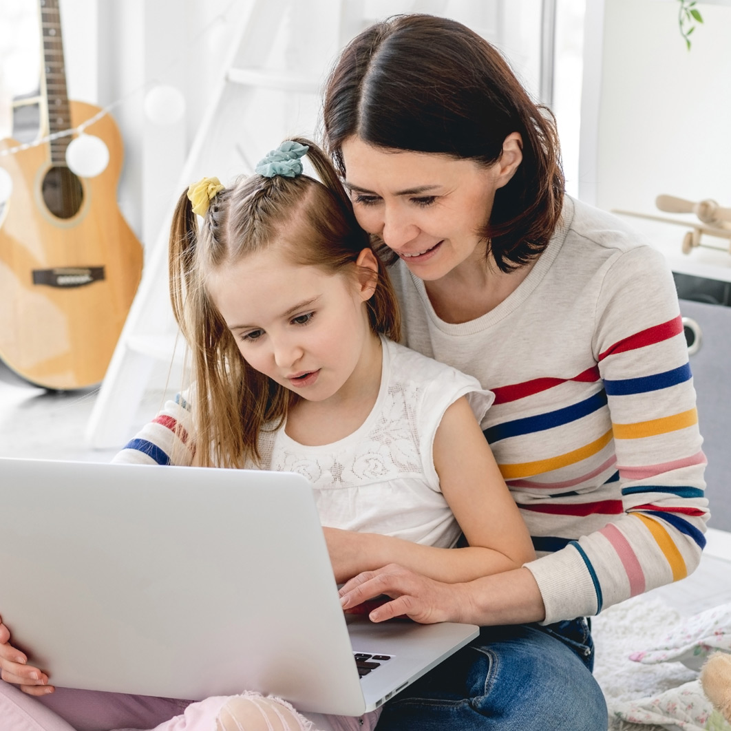 Girl with mom on laptop